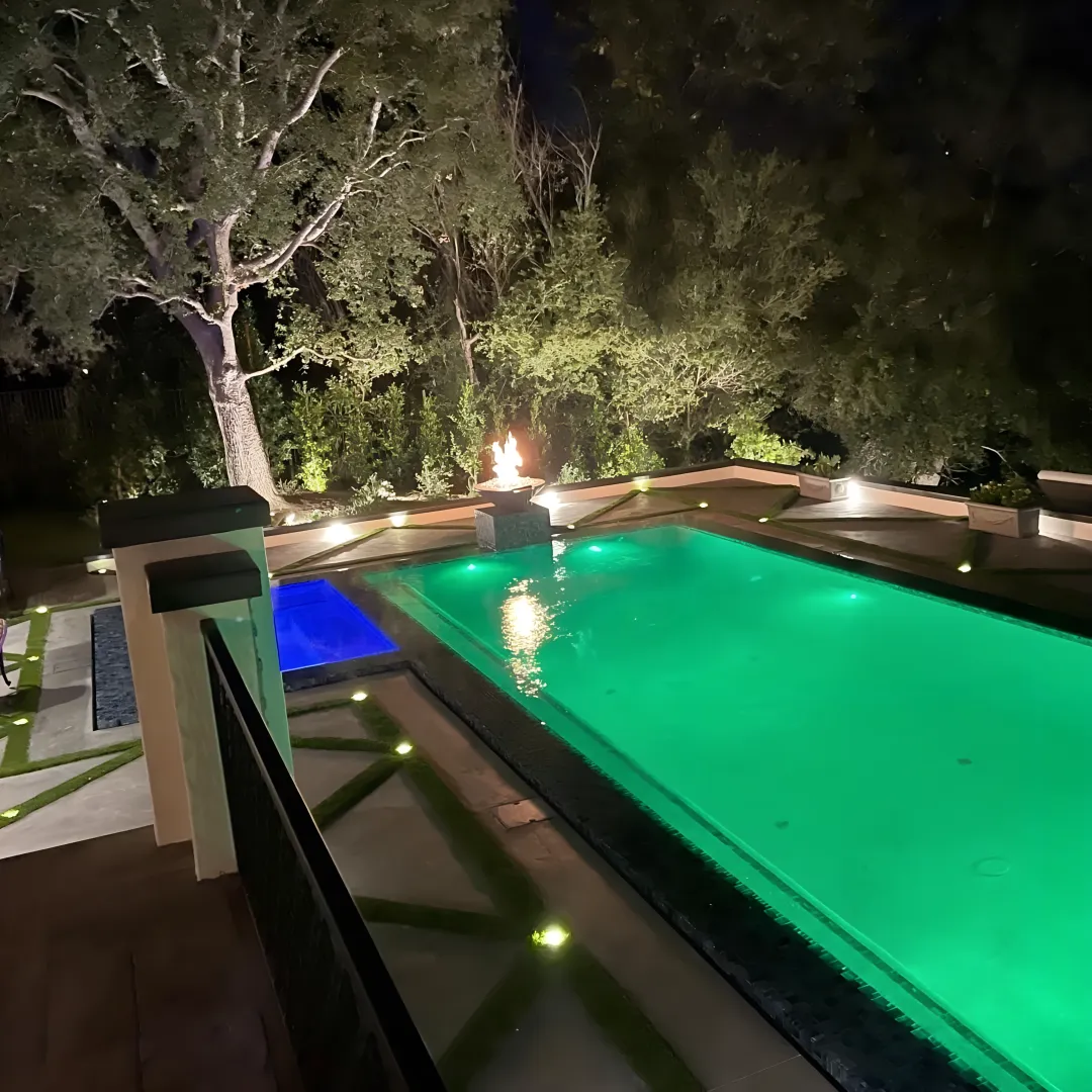 Contractor reviewing hillside pool and patio plans