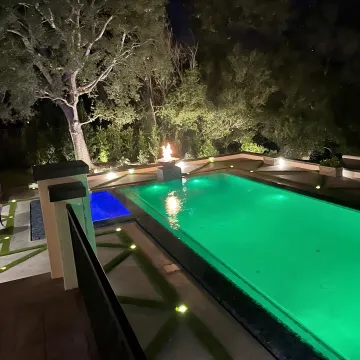 Contractor reviewing hillside pool and patio plans
