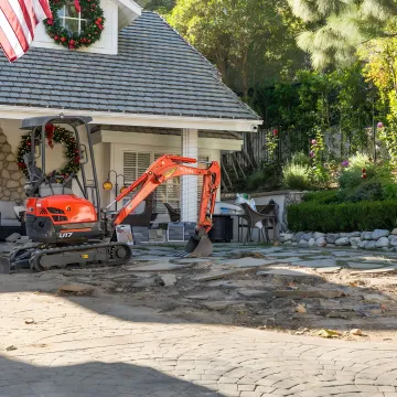 Hardscape crew installing a backyard patio