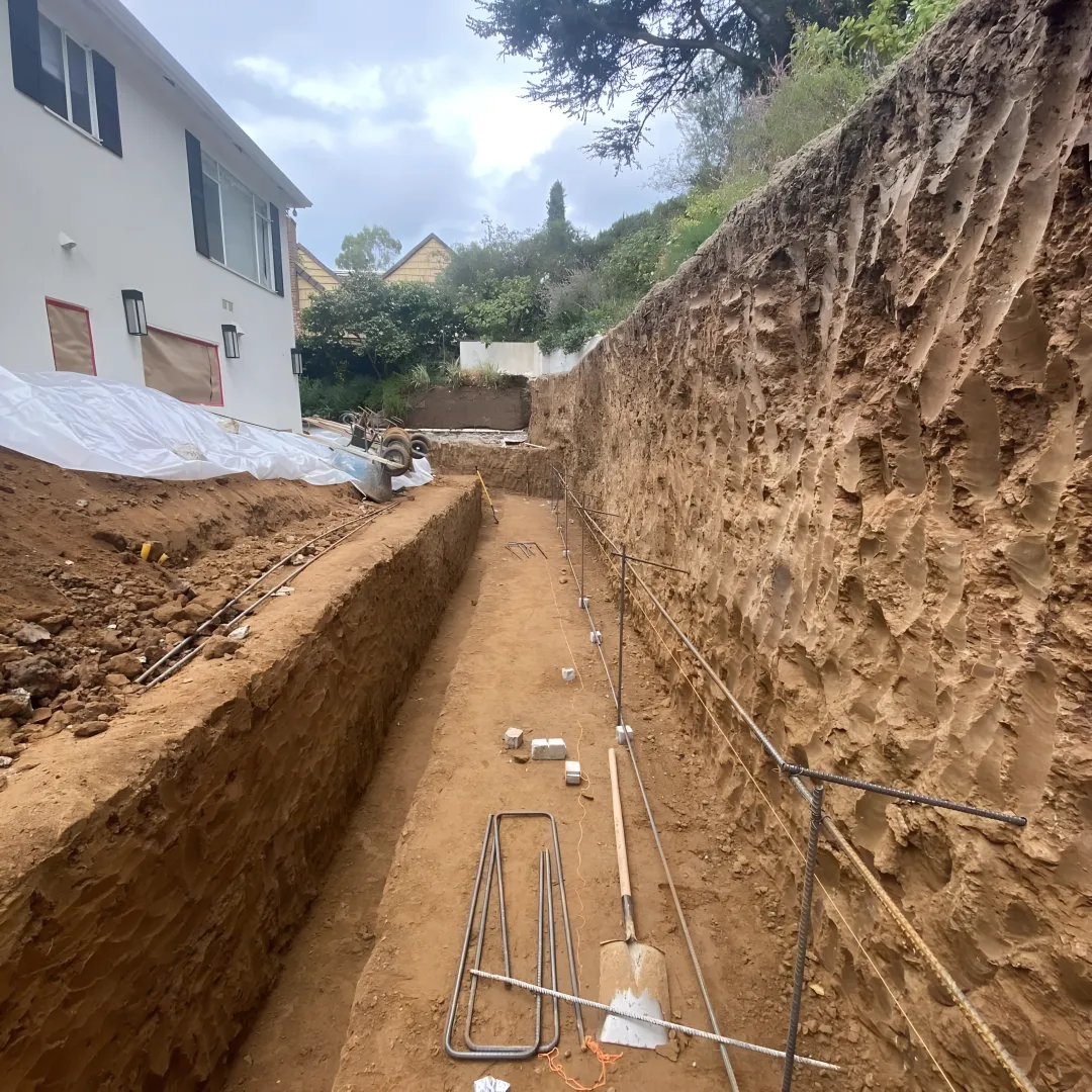Grading and drainage contractors working on a hillside