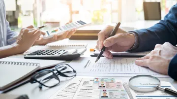 Bank compliance officer reviewing corporate account documents and KYC records