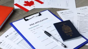 Canadian immigration and visa application documents on office desk