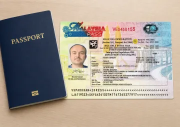 Malaysian Employment Pass visa document and passport for foreign business owners