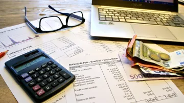 French tax and VAT compliance documents with calculator and euro currency