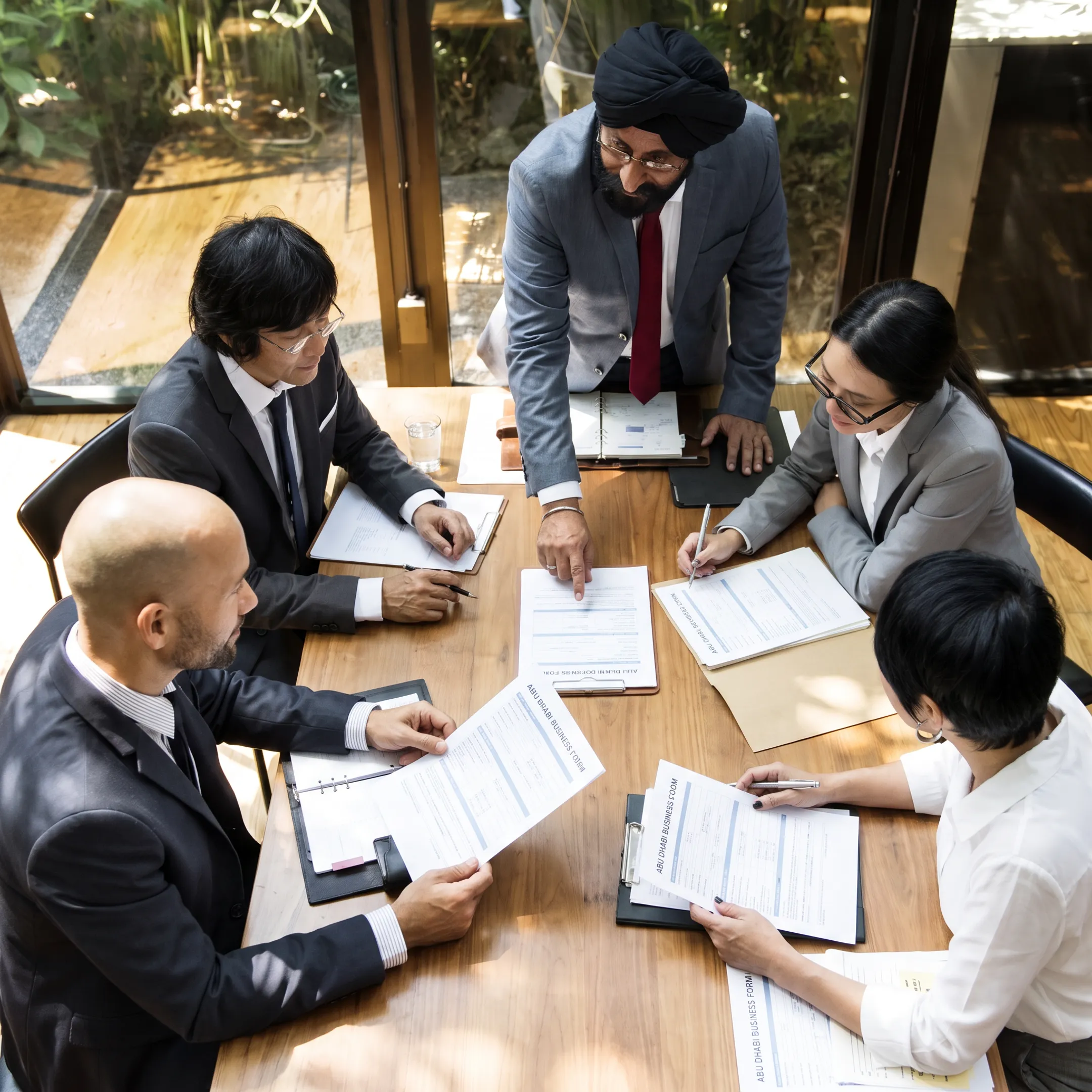 Business advisors discussing Abu Dhabi company formation documents with an American entrepreneur