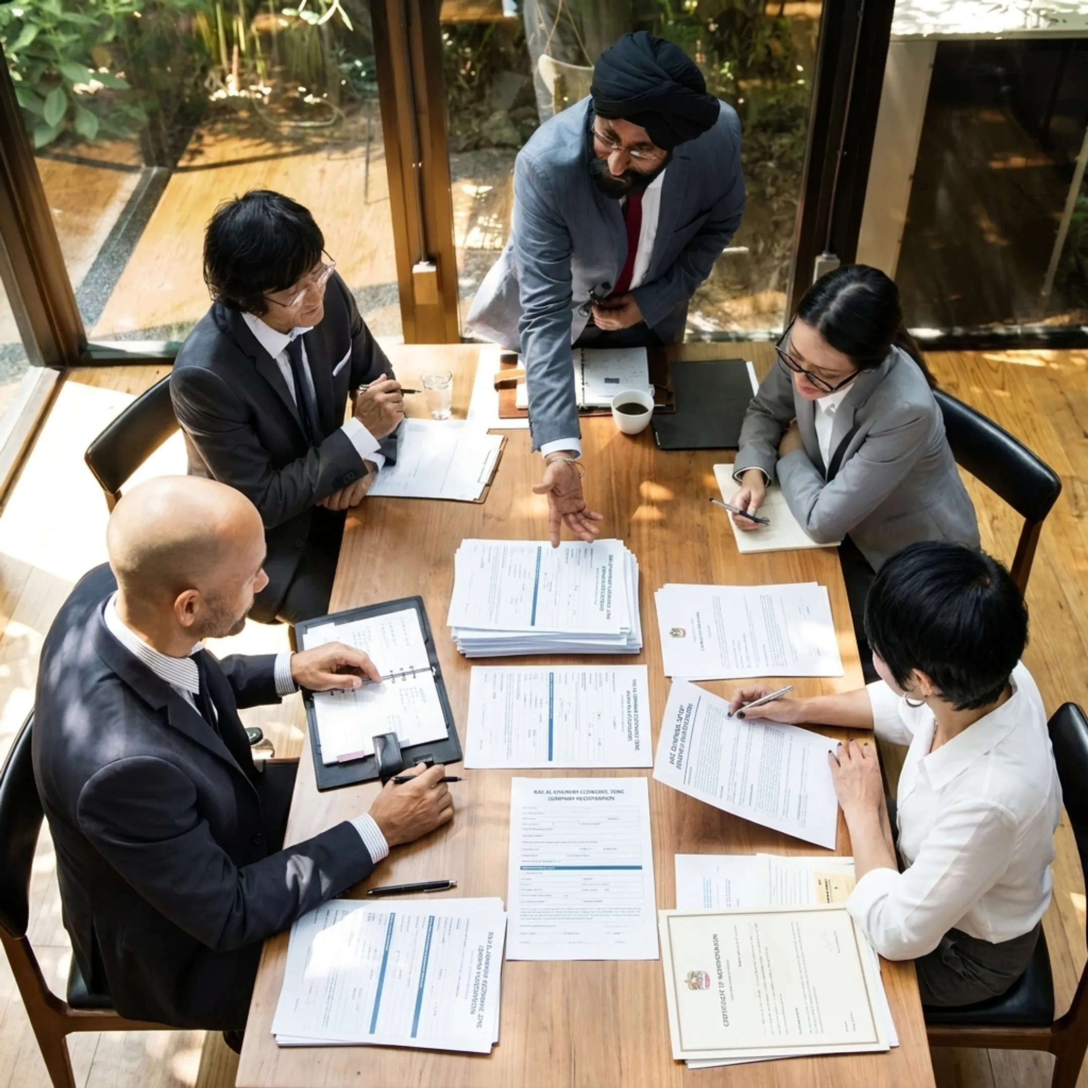 Business professionals reviewing company setup documents in a modern Ras Al Khaimah office