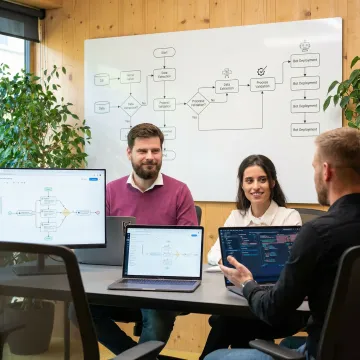 RPA implementation team reviewing automation workflow diagrams and deployment steps