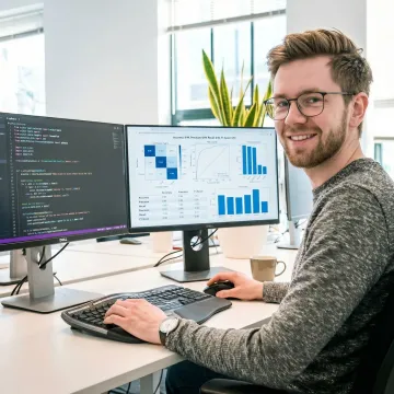 Data scientist working through a structured machine learning model development process on multiple screens