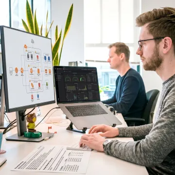 IT consultants reviewing cloud infrastructure dashboards