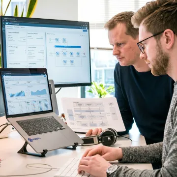 SAP consultants reviewing enterprise system dashboards