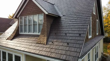 Metal shingle roofing replicating cedar shake aesthetic on residential home