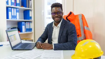 Professional contractor reviewing remodeling warranty documentation at job site desk