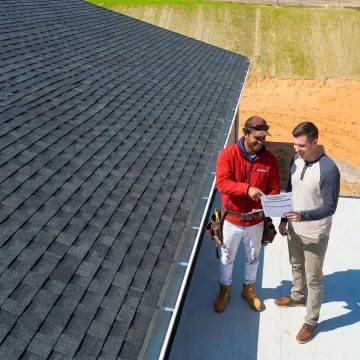Roofing contractor reviewing warranty program details