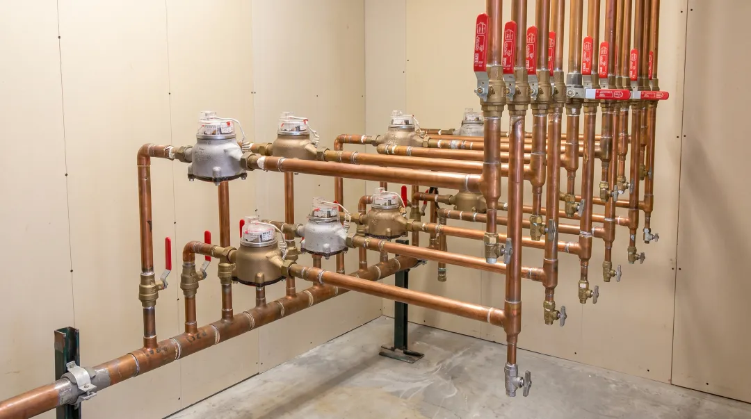 Industrial water meter installation in commercial facility mechanical room