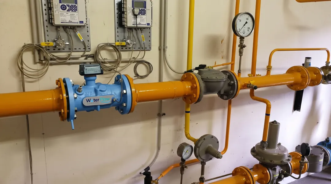 Commercial water meter installation showing pipes and turbine flow mechanism