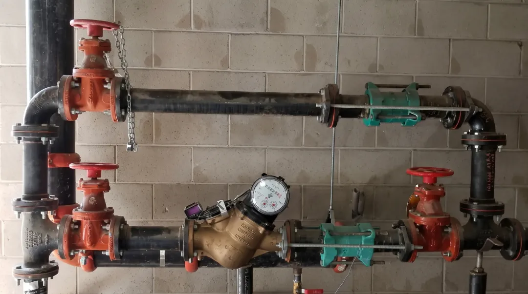 Commercial compound water meter installation in industrial mechanical room