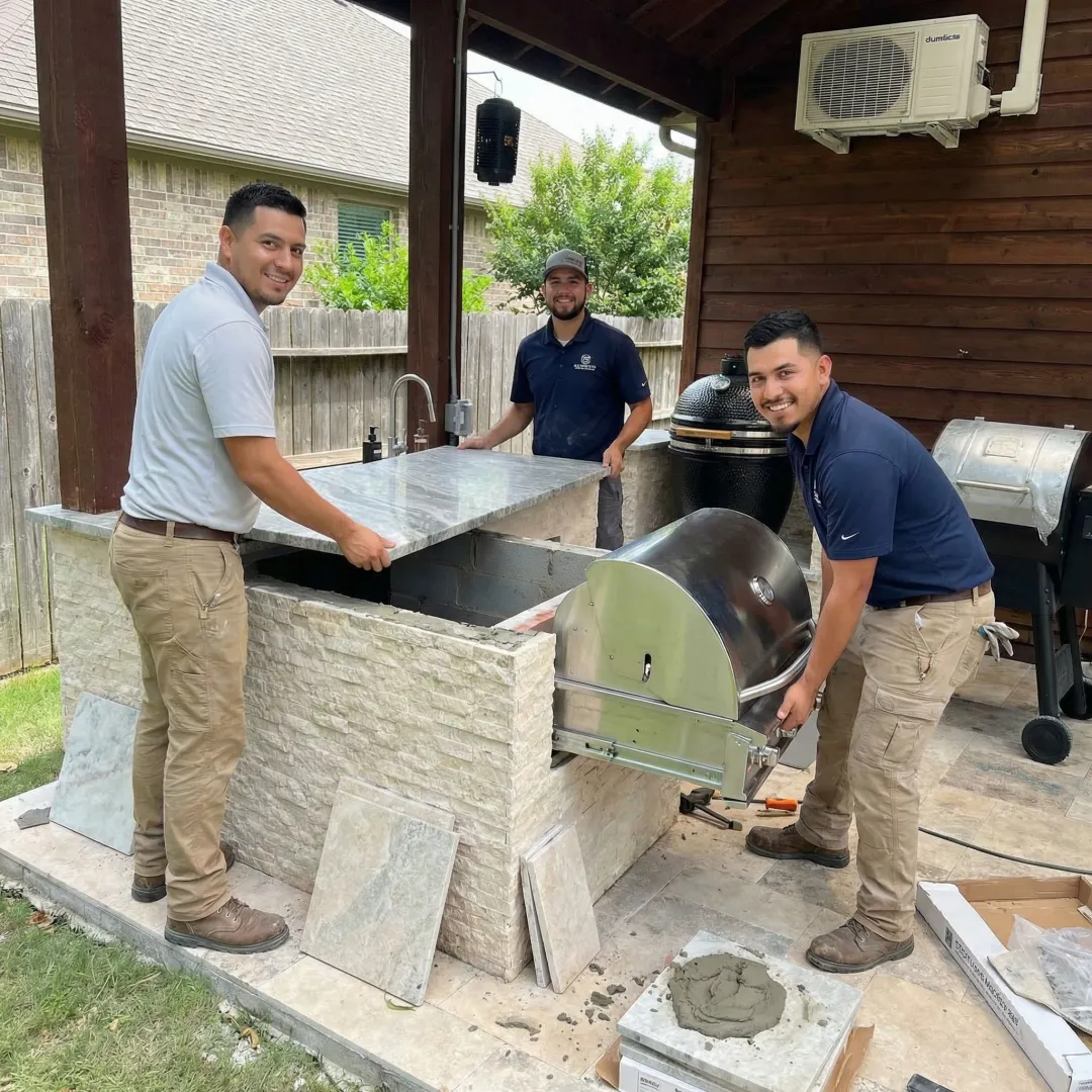 Contractor installing stone countertop in outdoor kitchen construction project