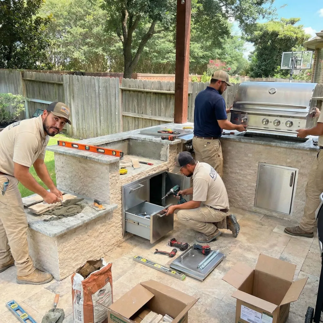 Construction crew building outdoor kitchen foundation and installing stone countertops