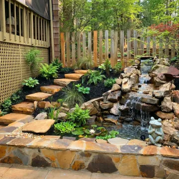 Custom designed water feature with natural stone in Marietta landscape