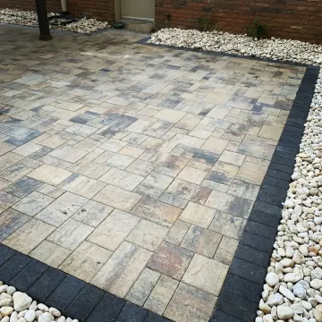 Close-up of premium Belgard paving stones being professionally installed