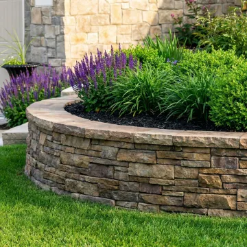 Professional garden wall construction with stone pavers and landscaping