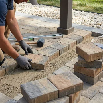 Close-up of premium stone pavers being professionally installed