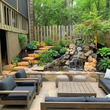 Beautiful custom landscape design with patio, plants, and outdoor living space