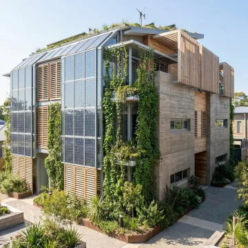 Modern sustainable green building with solar panels and living walls showcasing eco-friendly architecture