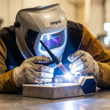 Close-up of precision welding operation on industrial component