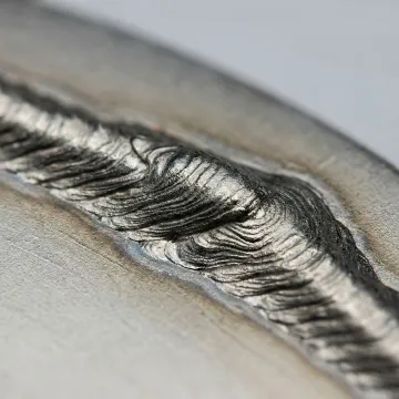 Close-up view of laser deposition weld bead on precision industrial component showing controlled material addition