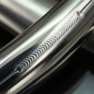 Close-up of precision manual TIG weld on stainless steel component showing clean bead profile