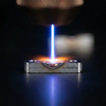 Close-up of precision laser welding process on small metal component