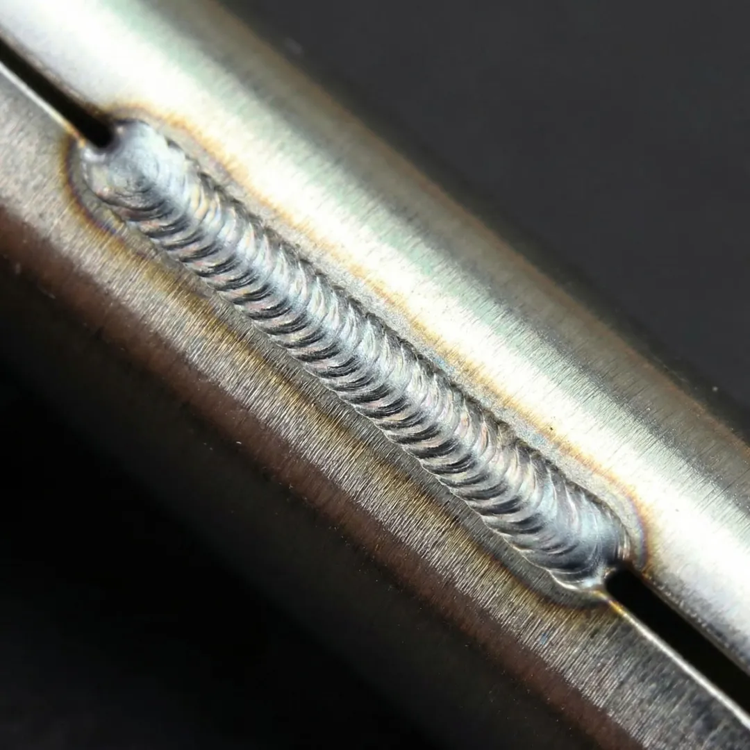 Close-up of clean precision TIG weld bead on stainless steel industrial component