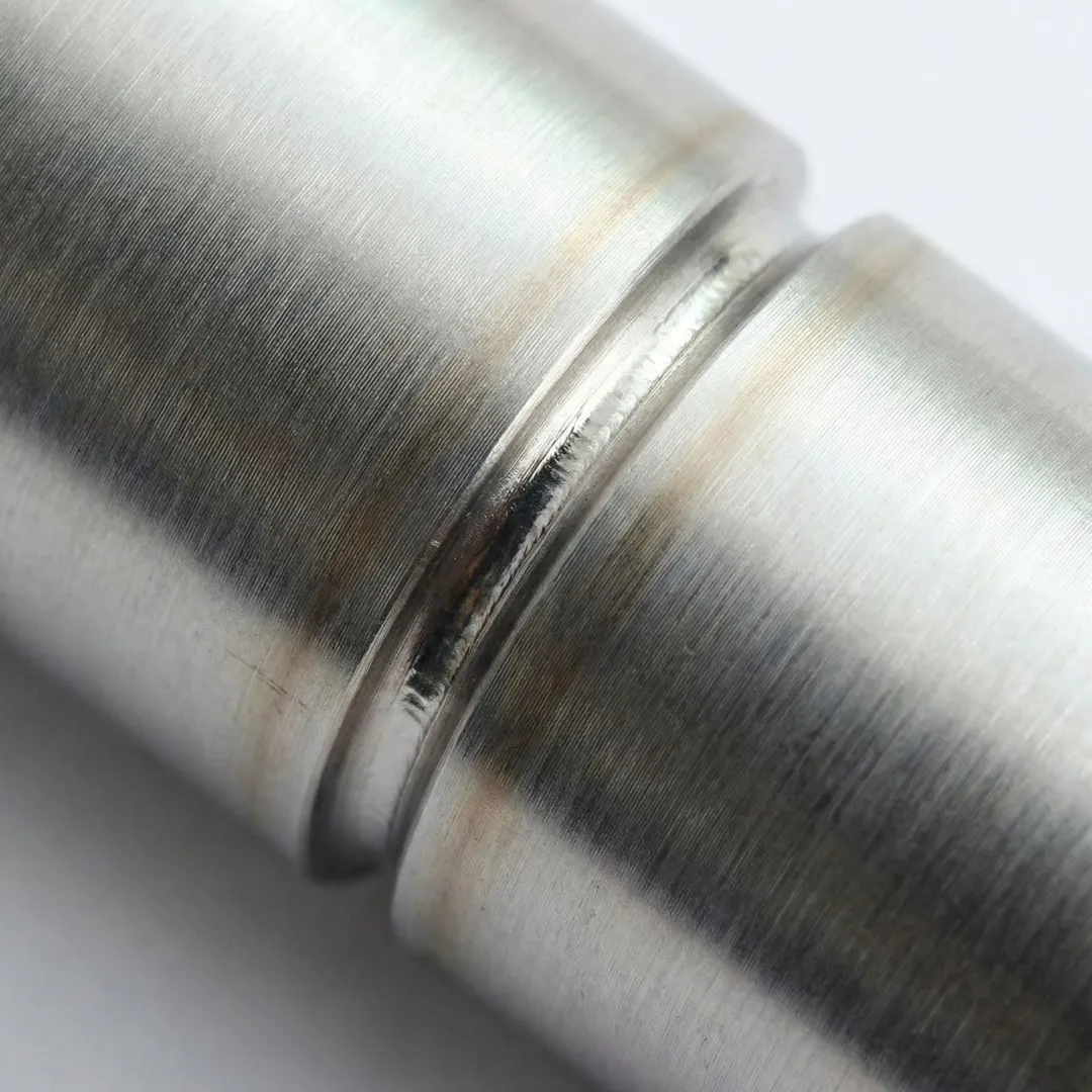 Close-up view of precision SST microwelding under magnification showing clean weld bead