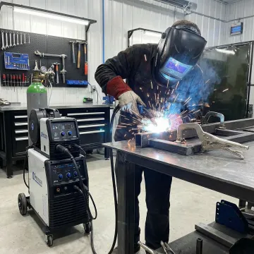 Professional MIG welder working on metal fabrication project in Orange County workshop