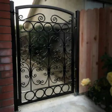 Elegant custom wrought iron gate with intricate scrollwork design