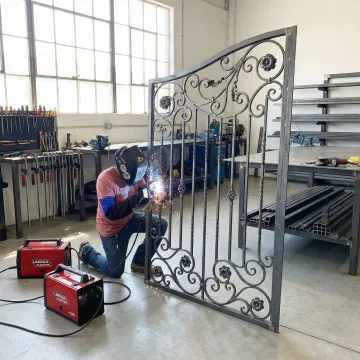 Skilled welder crafting custom wrought iron gate components