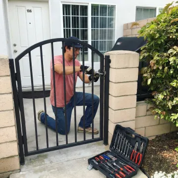Professional fence maintenance technician working on fence repair in Westminster