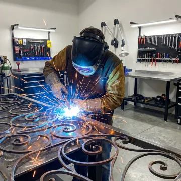 Skilled welder creating custom wrought iron artwork