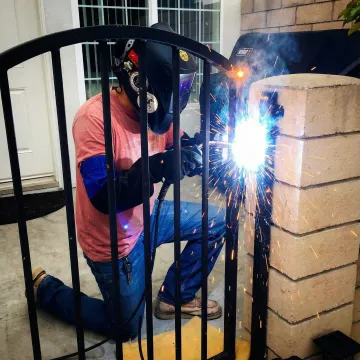 Professional welder performing MIG welding on metal fabrication project
