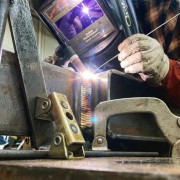 Close-up of precision welding on heavy structural steel beam