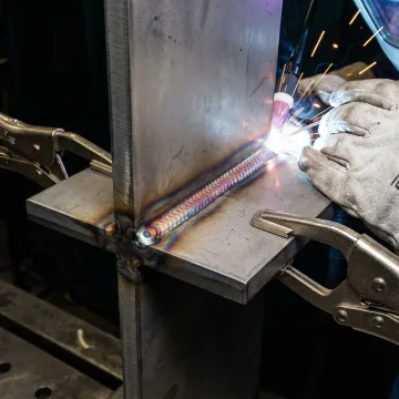 Close-up of precision welding work on industrial steel components