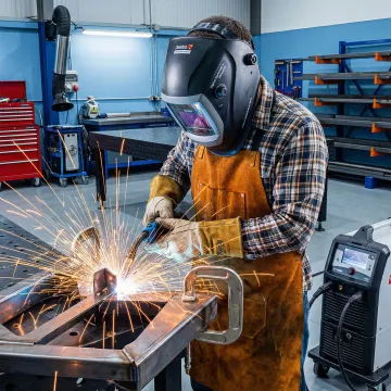 Professional welder working on custom metal fabrication project