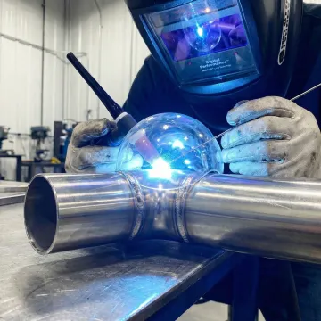 Close-up of precision TIG welding creating clean weld bead on industrial stainless steel pipe