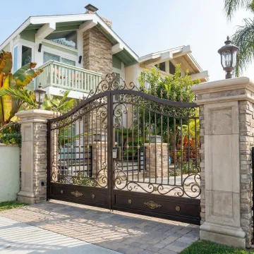 Custom wrought iron driveway gate with modern design elements in Poway residential setting