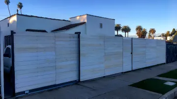 Custom wrought iron automatic gate with ornate design