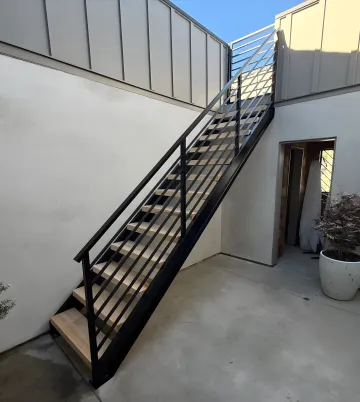 Elegant custom ironwork combining wood and metal elements in modern design