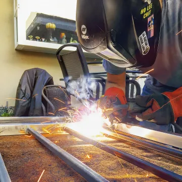 Professional iron fabrication workshop with custom metalwork pieces