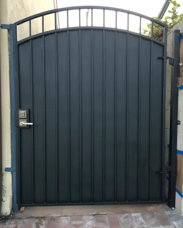 Skilled welder fabricating custom ornate gate in workshop