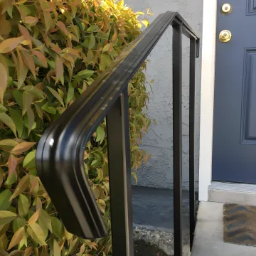 Professional fence installation contractor working on custom wrought iron fence